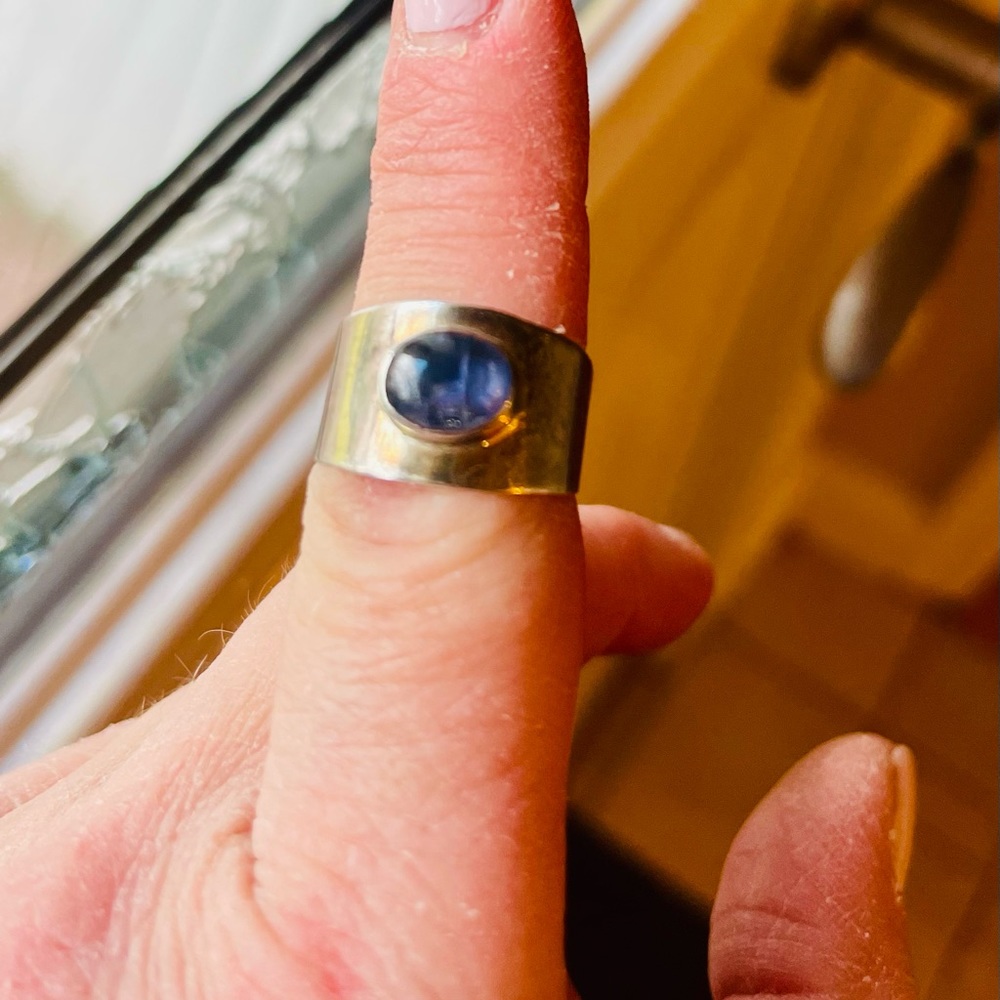 Silver ring with bluish purple stone